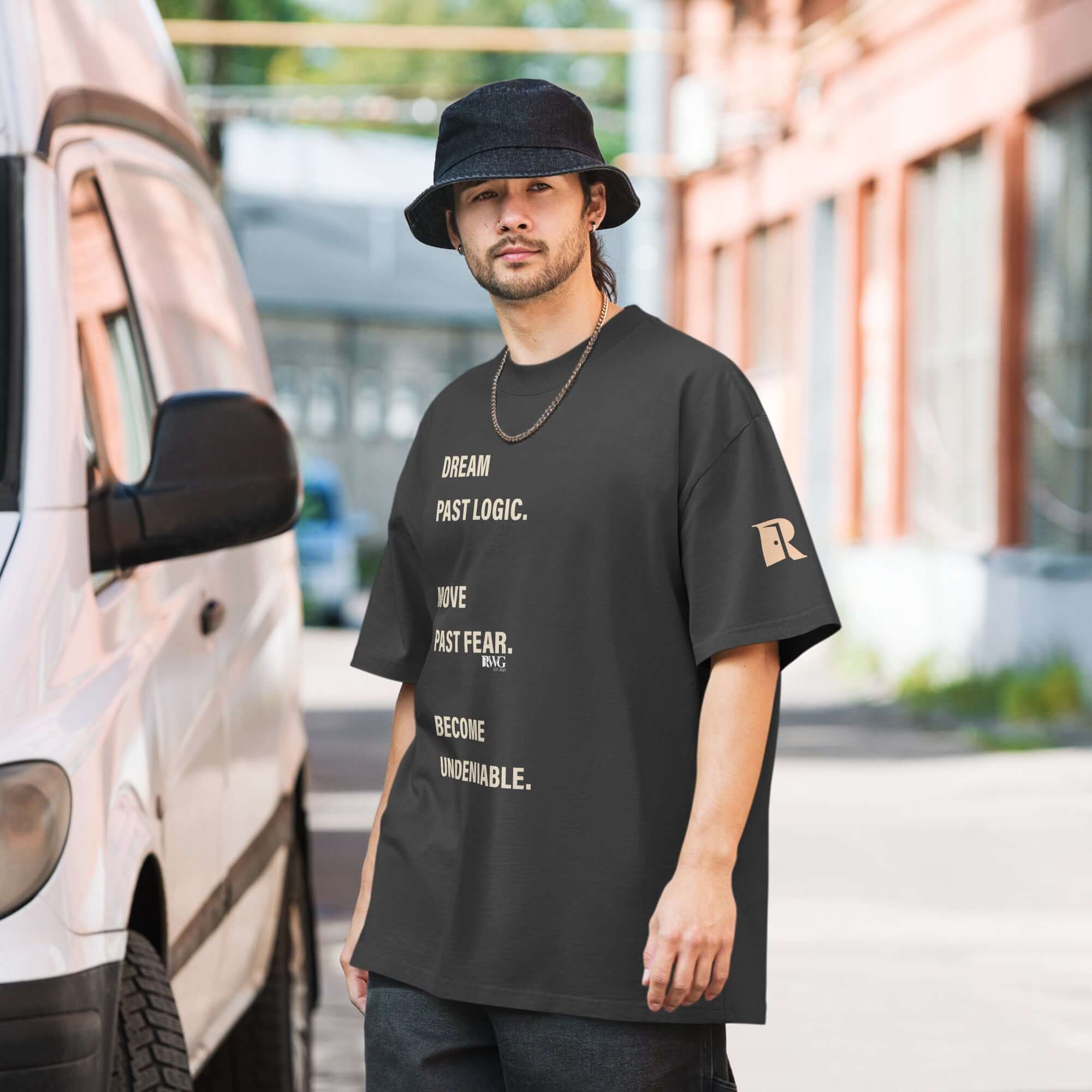 Become Undeniable Tee worn by a model in casual urban setting with motivational text.