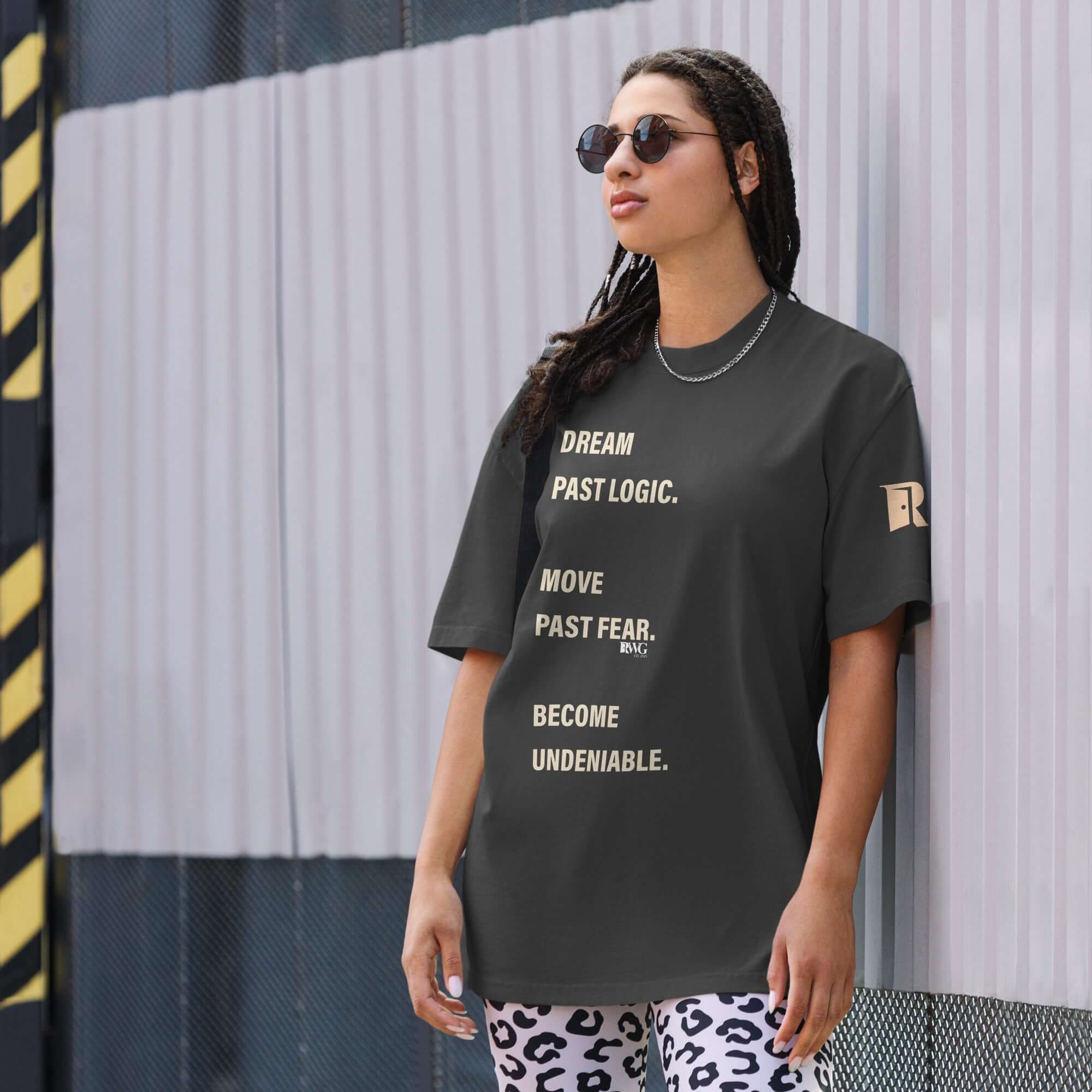 Become Undeniable Tee worn by a confident woman, featuring motivational text on a stylish design.